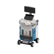 Model of a medical ultrasound machine on wheels with screens and controls.